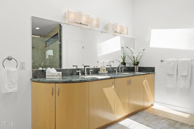 bathroom with vanity and a shower with shower door