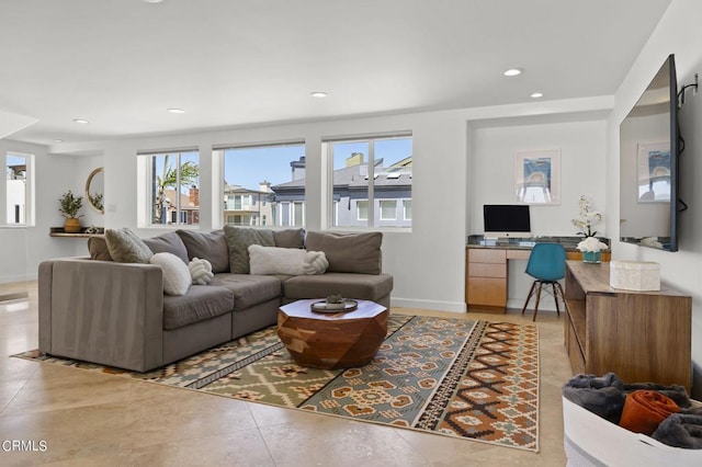 living room with a healthy amount of sunlight and light tile patterned flooring