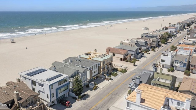 birds eye view of property with a beach view and a water view