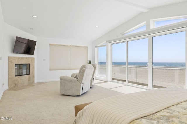 bedroom with a premium fireplace, a water view, lofted ceiling with beams, a beach view, and access to outside