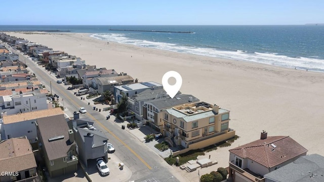 aerial view featuring a view of the beach and a water view