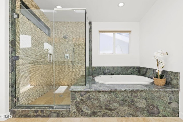 bathroom featuring separate shower and tub