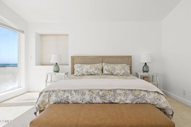 carpeted bedroom featuring multiple windows