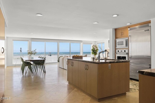3757 Ocean Dr, Oxnard, CA 93035 - kitchen featuring built in appliances, a center island with sink, recessed lighting, modern cabinets, and light tile patterned flooring