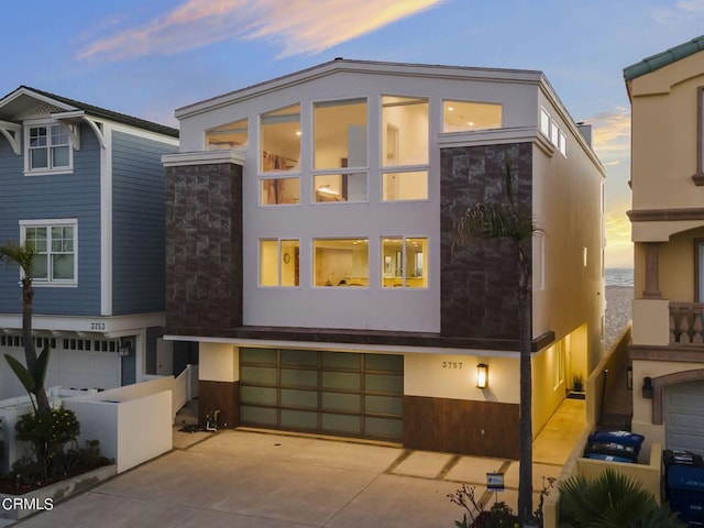 3757 Ocean Dr, Oxnard, CA 93035 - view of front of property featuring a garage, stucco siding, concrete driveway, and stone siding