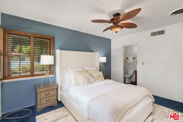 bedroom with ceiling fan and a textured ceiling