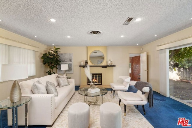 carpeted living room featuring a textured ceiling