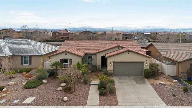 view of front of property featuring a garage and a mountain view