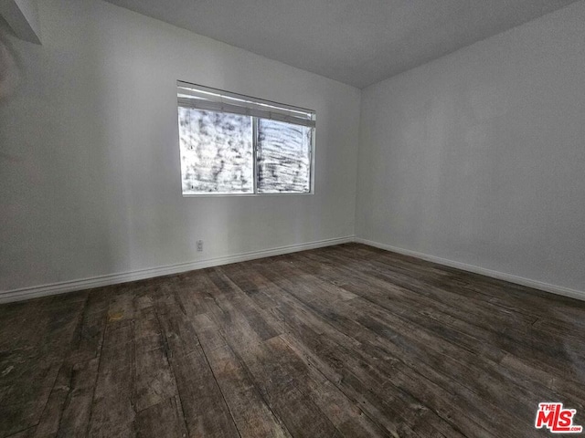 empty room featuring dark wood-type flooring