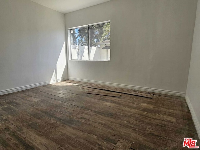 spare room with dark hardwood / wood-style floors