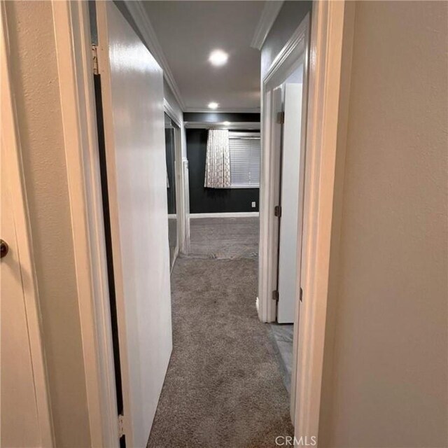 corridor with dark carpet and ornamental molding