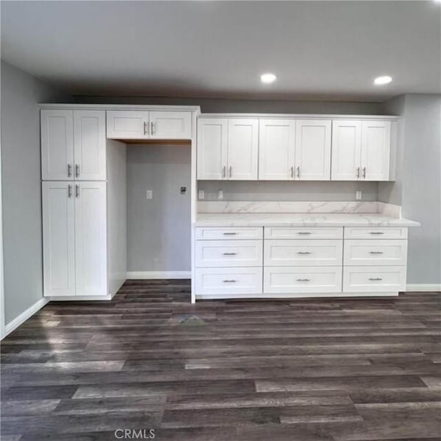 kitchen featuring dark hardwood / wood-style flooring and white cabinets