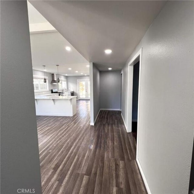 hallway with dark hardwood / wood-style floors