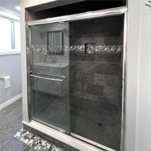 bathroom with tile patterned flooring and walk in shower