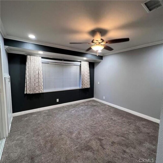 carpeted home theater featuring ornamental molding and ceiling fan