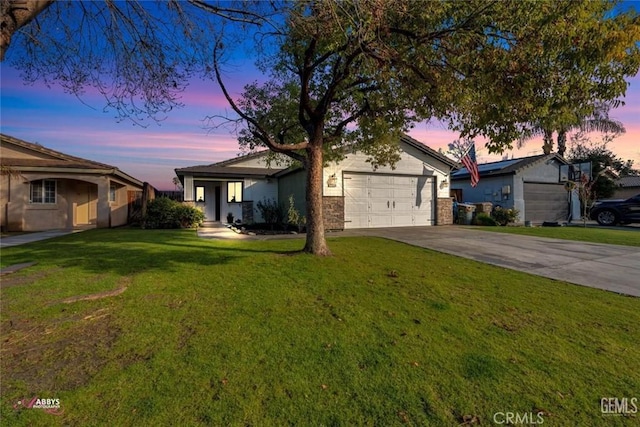 ranch-style house featuring a garage and a yard