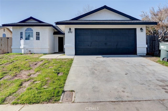 ranch-style house featuring a garage and a front yard