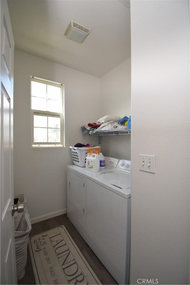 laundry room with dark wood-type flooring and washer and clothes dryer