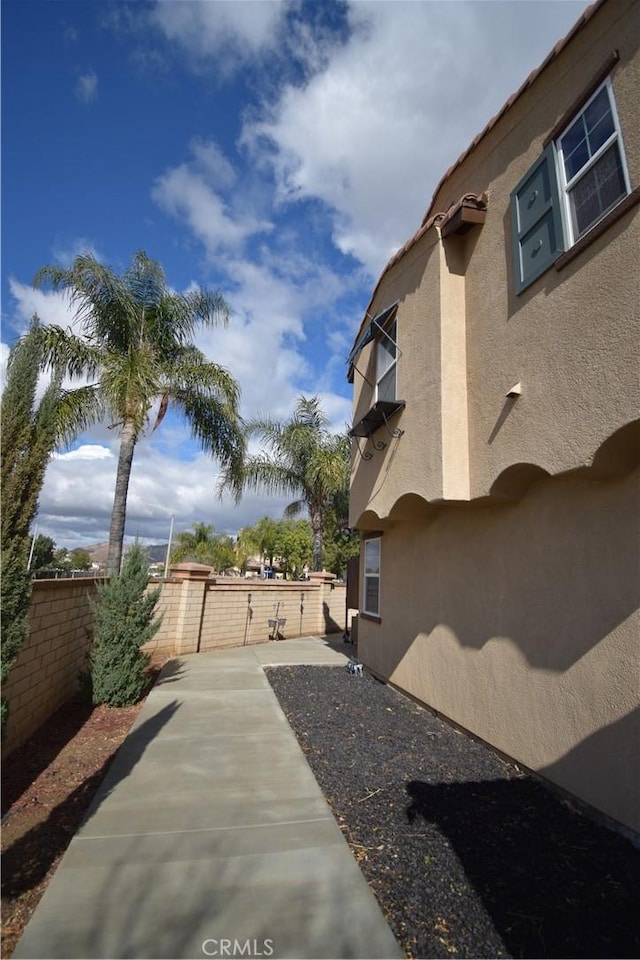 view of side of property featuring a patio area