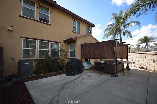 rear view of property with central AC, outdoor lounge area, and a patio