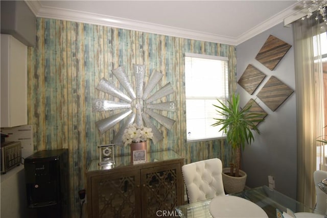 sitting room featuring ornamental molding and a wealth of natural light