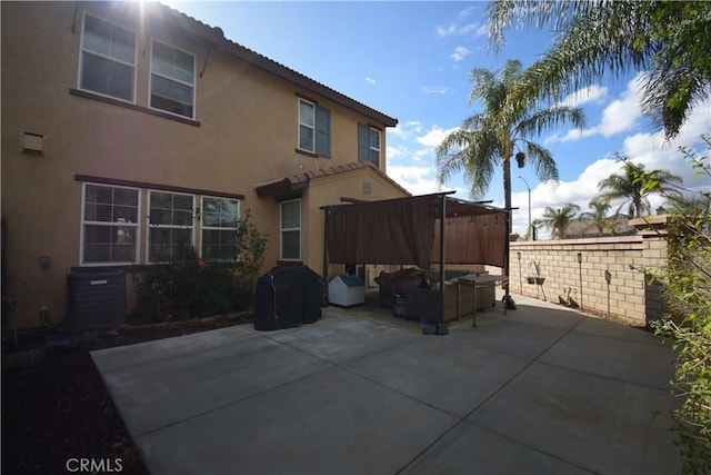 back of property featuring an outdoor living space, a patio area, and central air condition unit