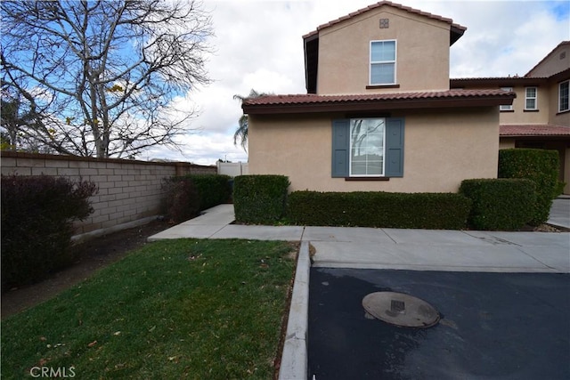 view of side of home featuring a lawn