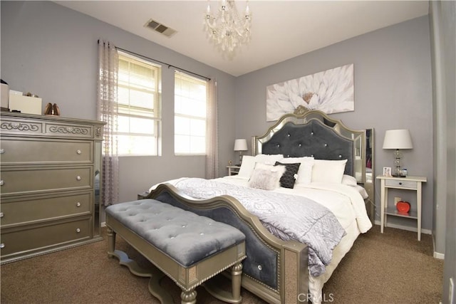 bedroom featuring dark carpet and an inviting chandelier