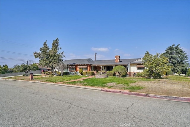 ranch-style house with a front lawn