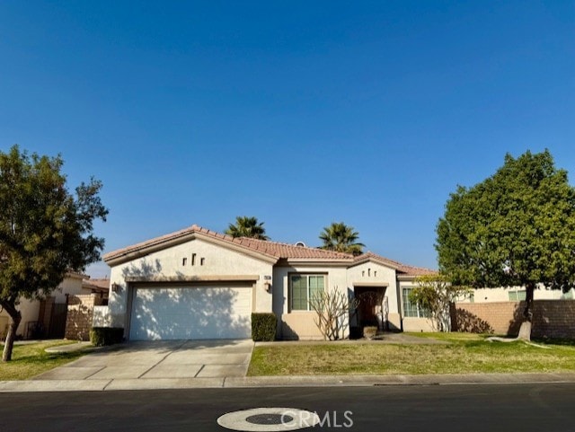 view of front facade with a garage and a front yard