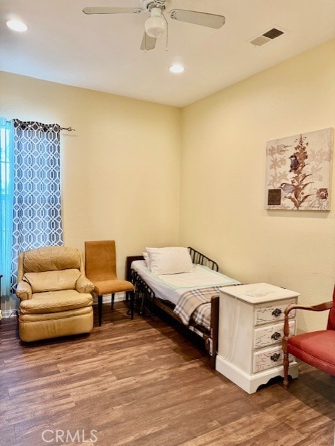 bedroom featuring wood-type flooring and ceiling fan