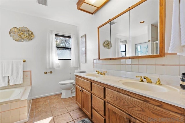 bathroom with tasteful backsplash, vanity, toilet, a bath, and tile patterned floors