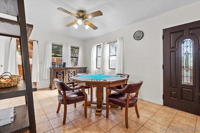 dining space featuring light tile patterned flooring and ceiling fan