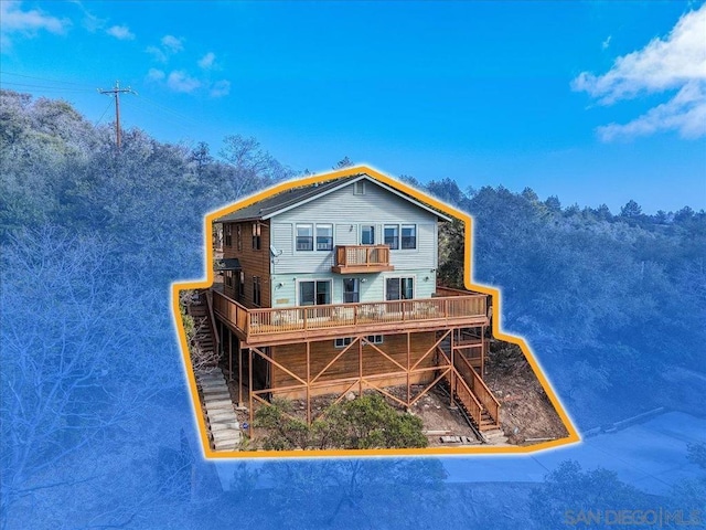 view of front of home featuring a wooden deck and a balcony