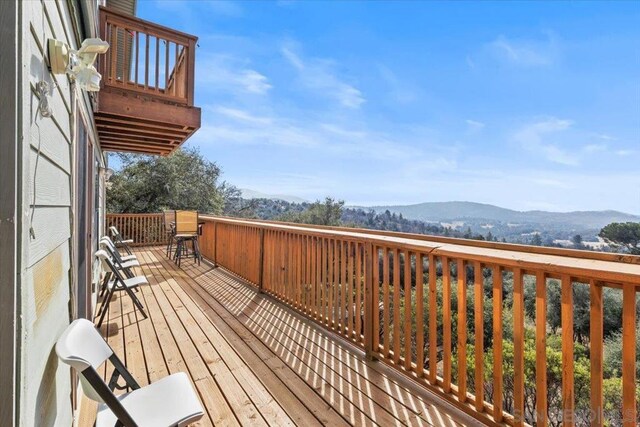 wooden deck featuring a mountain view