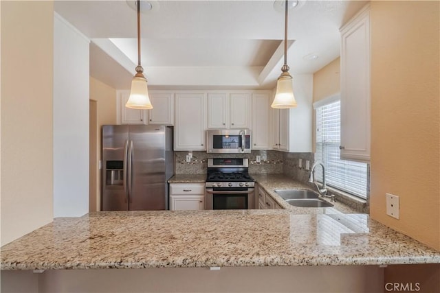 kitchen featuring sink, hanging light fixtures, kitchen peninsula, stainless steel appliances, and backsplash