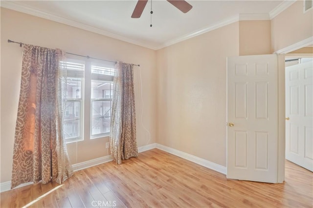 spare room with ceiling fan, ornamental molding, and light hardwood / wood-style flooring