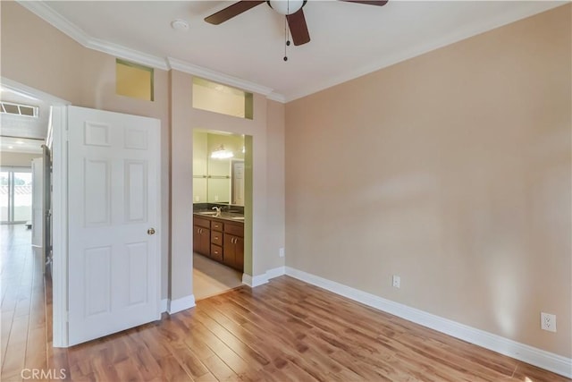 unfurnished bedroom with ornamental molding, light hardwood / wood-style floors, ceiling fan, and ensuite bathroom