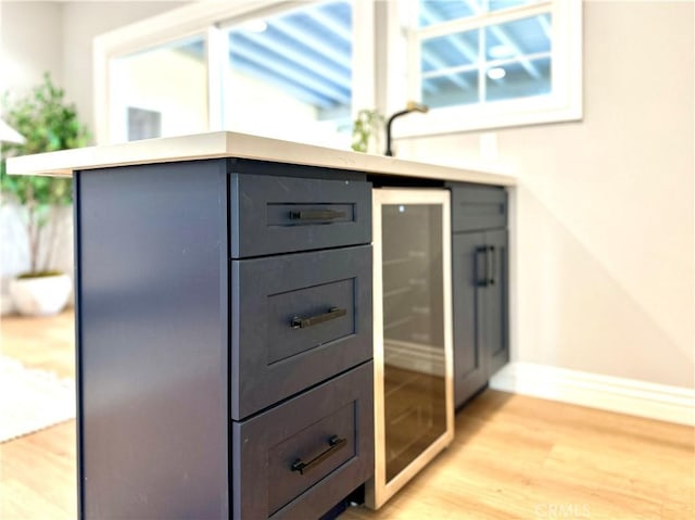 interior details featuring hardwood / wood-style flooring and wine cooler