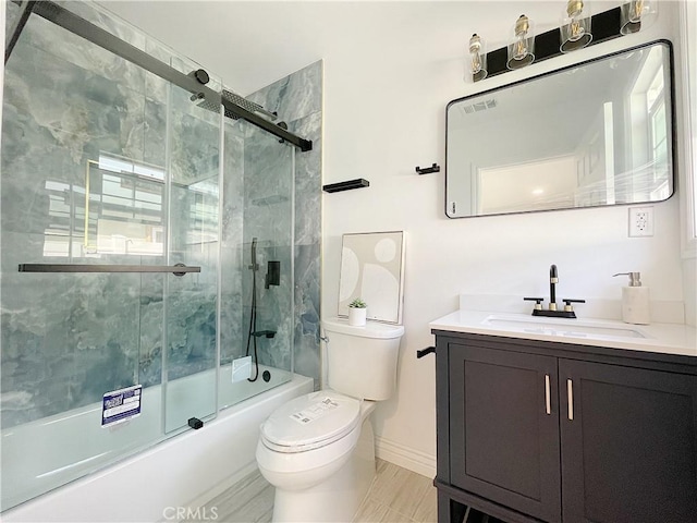 full bathroom featuring bath / shower combo with glass door, vanity, and toilet