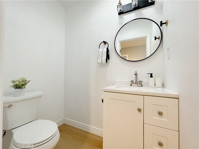 bathroom featuring vanity, hardwood / wood-style floors, and toilet