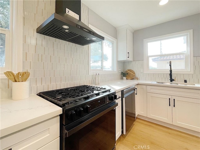 kitchen featuring ventilation hood, dishwasher, sink, white cabinets, and black range with gas cooktop