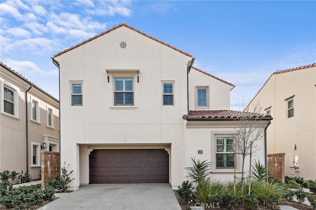 mediterranean / spanish-style home with a garage