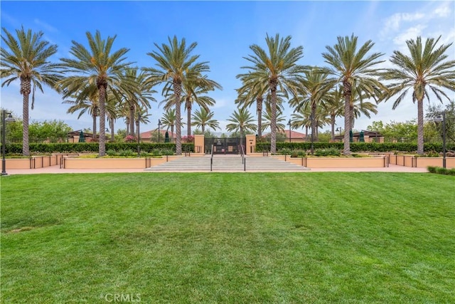 view of property's community with a lawn