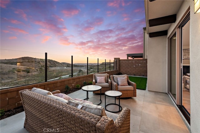 view of patio / terrace with outdoor lounge area, a mountain view, and fence