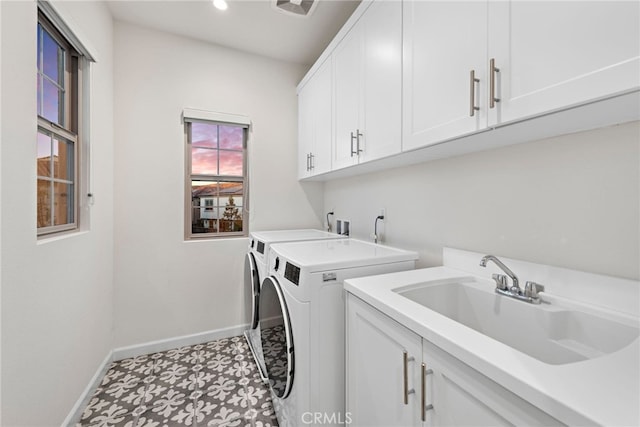 laundry area featuring recessed lighting, a sink, baseboards, cabinet space, and washing machine and clothes dryer