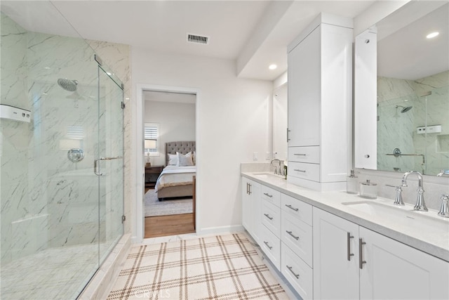 full bathroom with a sink, double vanity, connected bathroom, and visible vents