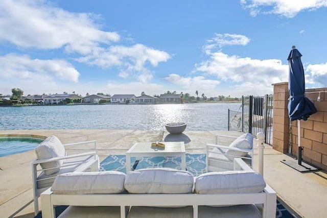 view of dock with a water view and a patio area