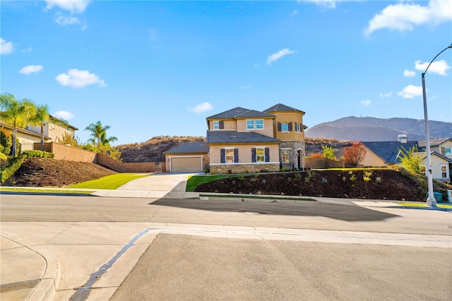 view of front of home with a garage and a mountain view