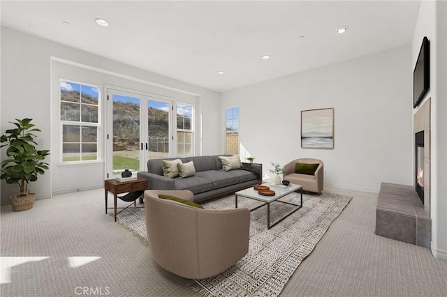 living room featuring light carpet and french doors